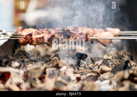 Close up marinated beef kebab. Shashlik preparing on barbecue grill over hot charcoal outdoors Stock Photo