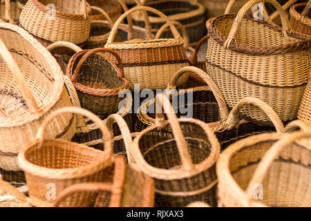 Hand made wicker woven baskets on display in a city fare. Handmade crafts Stock Photo