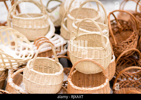 Hand made wicker woven baskets on display in a city fare. Handmade crafts Stock Photo