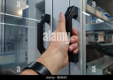 Hand opening the glass door Stock Photo