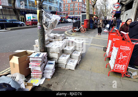 London, England, UK. Large pile of the London Evening Standard free daily newspaper outside Holborn underground station Stock Photo