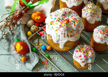 Springtime. Festive composition in rustic style. Easter cake and painted eggs on wooden table. Stock Photo