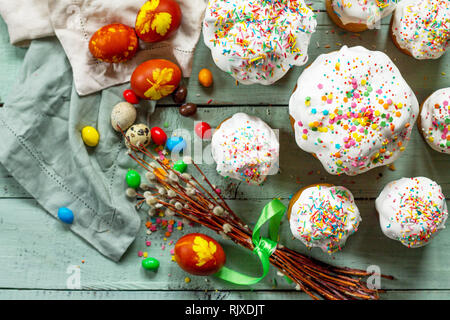 Easter cake and painted eggs on wooden table. Festive composition in rustic style, Springtime. Flat lay, top view background. Stock Photo