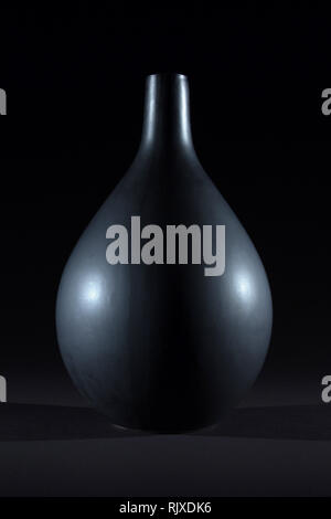 Matte black ceramic vase on black background isolated Stock Photo