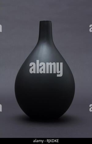 Matte black ceramic vase on black background isolated Stock Photo