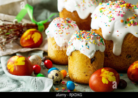Easter cake and painted eggs on wooden table. Festive composition in rustic style, Springtime. Flat lay, top view background. Stock Photo