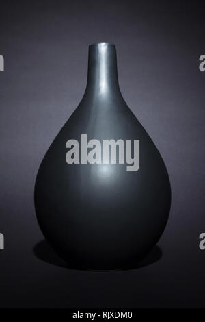 Matte black ceramic vase on black background isolated Stock Photo