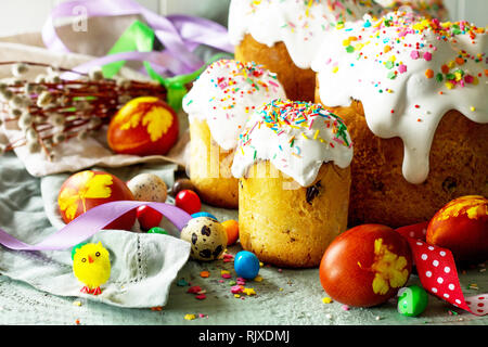 Springtime. Festive composition in rustic style. Easter cake and painted eggs on wooden table. Stock Photo