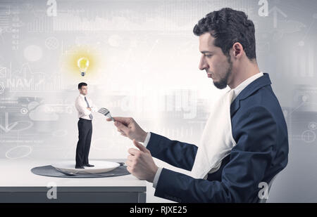 Giant businessman eating small man with financial background  Stock Photo