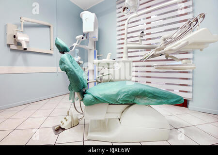 Empty dentist surgery with examination couch and equipment in a medical and healthcare concept Stock Photo