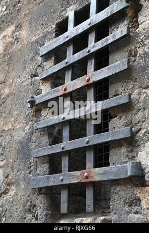 Metal grating on the window of the fortress wall Stock Photo