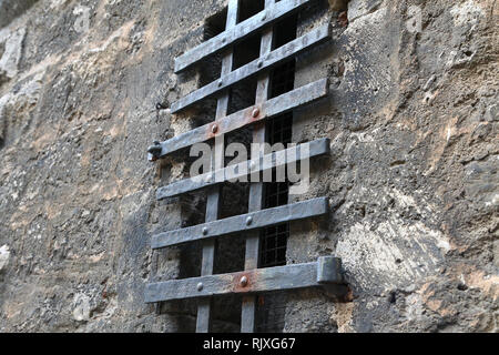 Metal grating on the window of the fortress wall Stock Photo