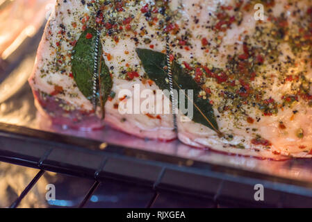 closeup view raw beef cross rib chunk on oven tray with foil inside oven Stock Photo