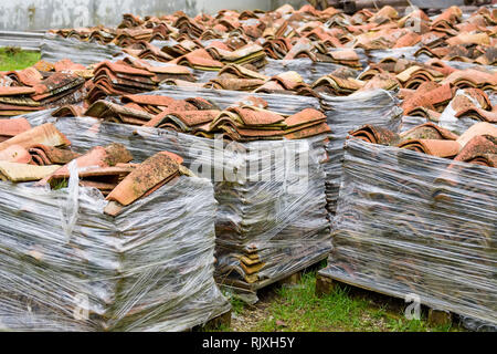 View of many red tiles for roof stacked on ground Stock Photo