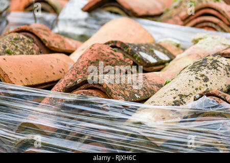View of many red tiles for roof stacked on ground Stock Photo