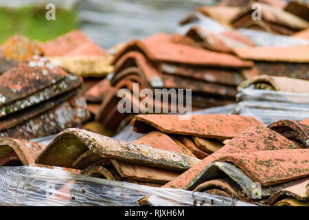 View of many red tiles for roof stacked on ground Stock Photo