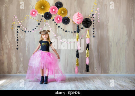 Cute beautifull girl lady posing in fancy violet dress skirt with number seven celebrating her birthday day with fun and joyful in studio scene . Stock Photo