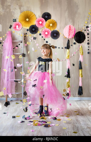 Cute beautifull girl lady posing in fancy violet dress skirt with number seven celebrating her birthday day with fun and joyful in studio scene . Stock Photo