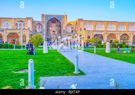 ISFAHAN, IRAN - OCTOBER 19, 2017: The old Qeysarie Gates with partly preserved decorations located in Naqsh-e Jahan Square, on October 19 in Isfahan Stock Photo