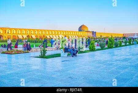 ISFAHAN, IRAN - OCTOBER 19, 2017: The crowded central Naqsh-e Jahan Square in the evening, its the best place to spend an evening, meet friends play w Stock Photo