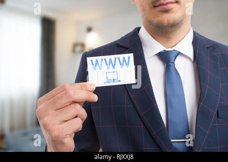 Man advertising business by presenting card with www letters and laptop symbol as visit our website concept Stock Photo