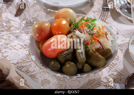 Canned tomatoes and cucumbers with black bread Stock Photo