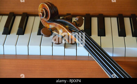 A violin lying on a piano Stock Photo