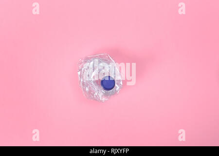 deformed plastic bottle on pink background Stock Photo