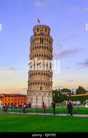 Pisa, Italy - October 25, 2018: Leaning Tower of Pisa, Italy against blue sunset sky and people around Stock Photo