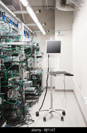 Tangled computer server cords in server room Stock Photo