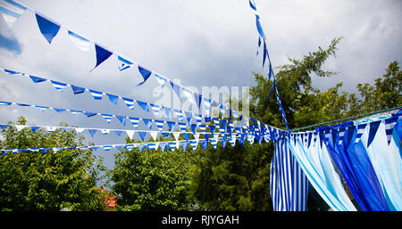 color flags garland on sky background. estival flag line with blue sky in background. Stock Photo