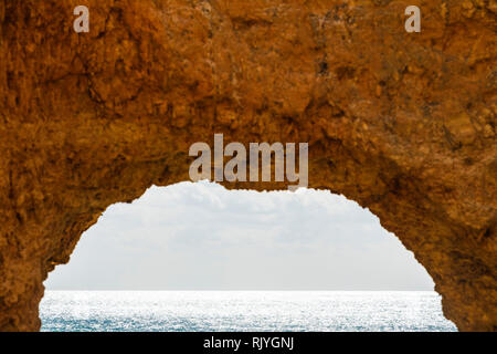 Looking through natural arch in cliff, Alvor, Algarve, Portugal, Europe Stock Photo