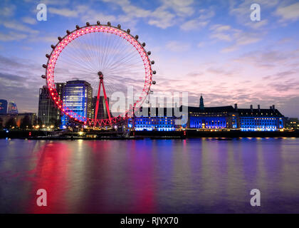 A twenty-second exposure, of the English London Eye and County Hall, taken to smooth out the River Thames. It was taken from near Westminster bridge. Stock Photo