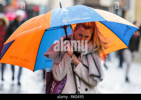 Bath, UK. 8th February, 2019. As storm Eric brings gales and heavy rain across the UK a pedestrian shopping in the centre of Bath is pictured carrying an umbrella as she braves the heavy rain and wind. Credit: Lynchpics/Alamy Live News Stock Photo