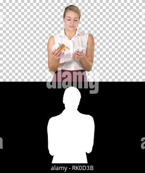 On Alpha Matte. Medium shot. Businesswoman with money counting them, Alpha Channel Professional shot in 4K resolution. 005. You can use it e.g. in you Stock Photo