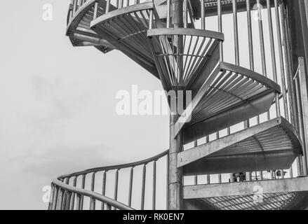 outdoor metal spiral staircase in black and white with copy space Stock Photo