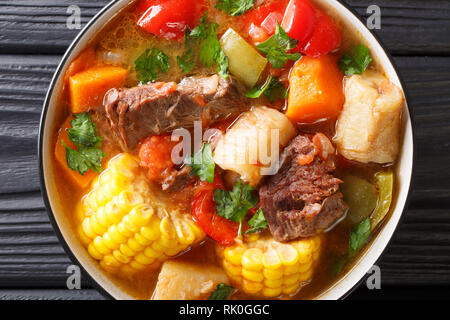 Sancocho Recipe a hearty and absolutely delicious stew made with meat, vegetables and spice close-up on a plate on the table. horizontal top view from Stock Photo
