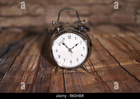 The old alarm clock on a light background Stock Photo
