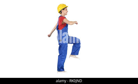Happy woman construction worker walking in funny way willing to work on white background. Stock Photo