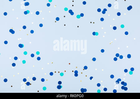 Blue background with gold and dark blue confetti. Christmas and Hanukkah, holiday concept. Horizontal Stock Photo