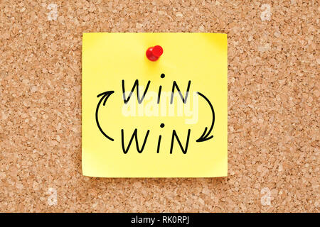 Win-Win arrows concept handwritten on yellow sticky note pinned on bulletin cork board. Stock Photo