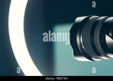 Camera lens and LED ring light in studio, photo and video production conceptual copy space Stock Photo