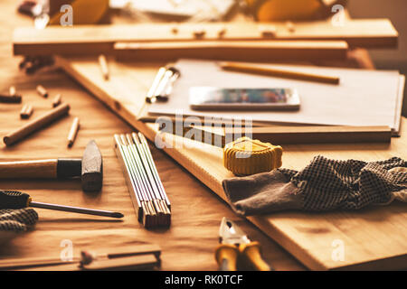 Various tools on carpentry woodwork workshop desk, selective focus with shallow depth of field Stock Photo