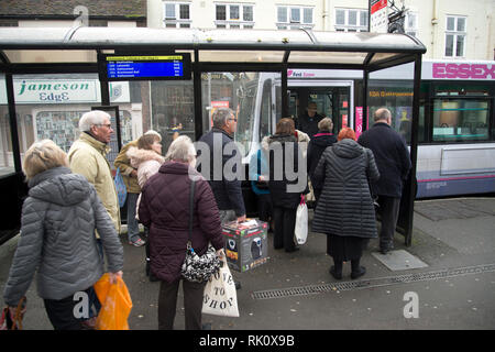 England. Essex. Chelmsford. Elderly passengers wait at the bus stop Stock Photo