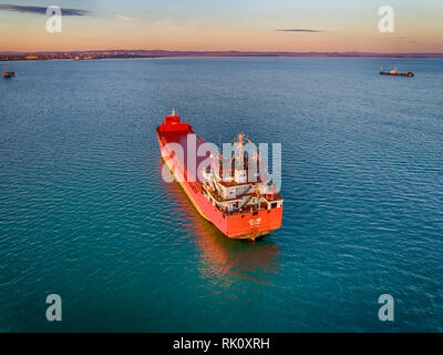 Aerial view of beautiful large ship at sunset. Colorful landscape with boat, sea, colorful sky. Stock Photo