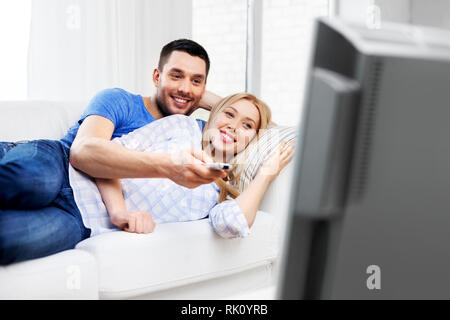 happy smiling couple watching tv at home Stock Photo