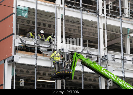 Construction workers at building site of new office building in central Edinburgh, Scotland, UK Stock Photo
