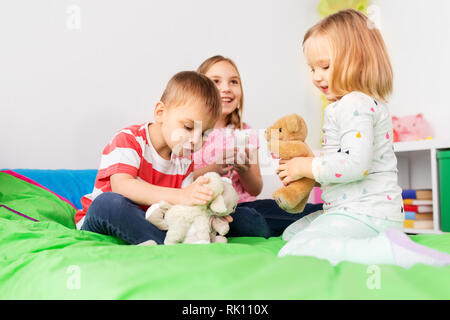 happy children playing with soft toys at home Stock Photo