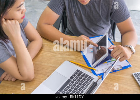 Man showing data in tablet to teammate Stock Photo