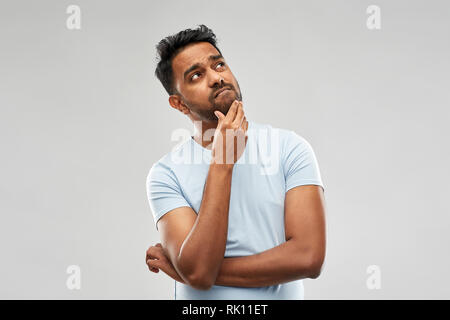 indian man thinking and looking up Stock Photo